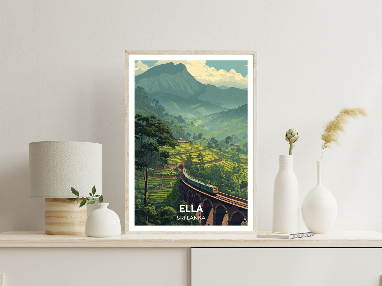 Framed artwork of Ella, Sri Lanka with a scenic view on a white wall.